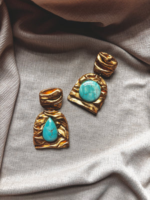 Ava & Azar handcrafted gold statement earrings with magnesite turquoise, inspired by Persian architecture.