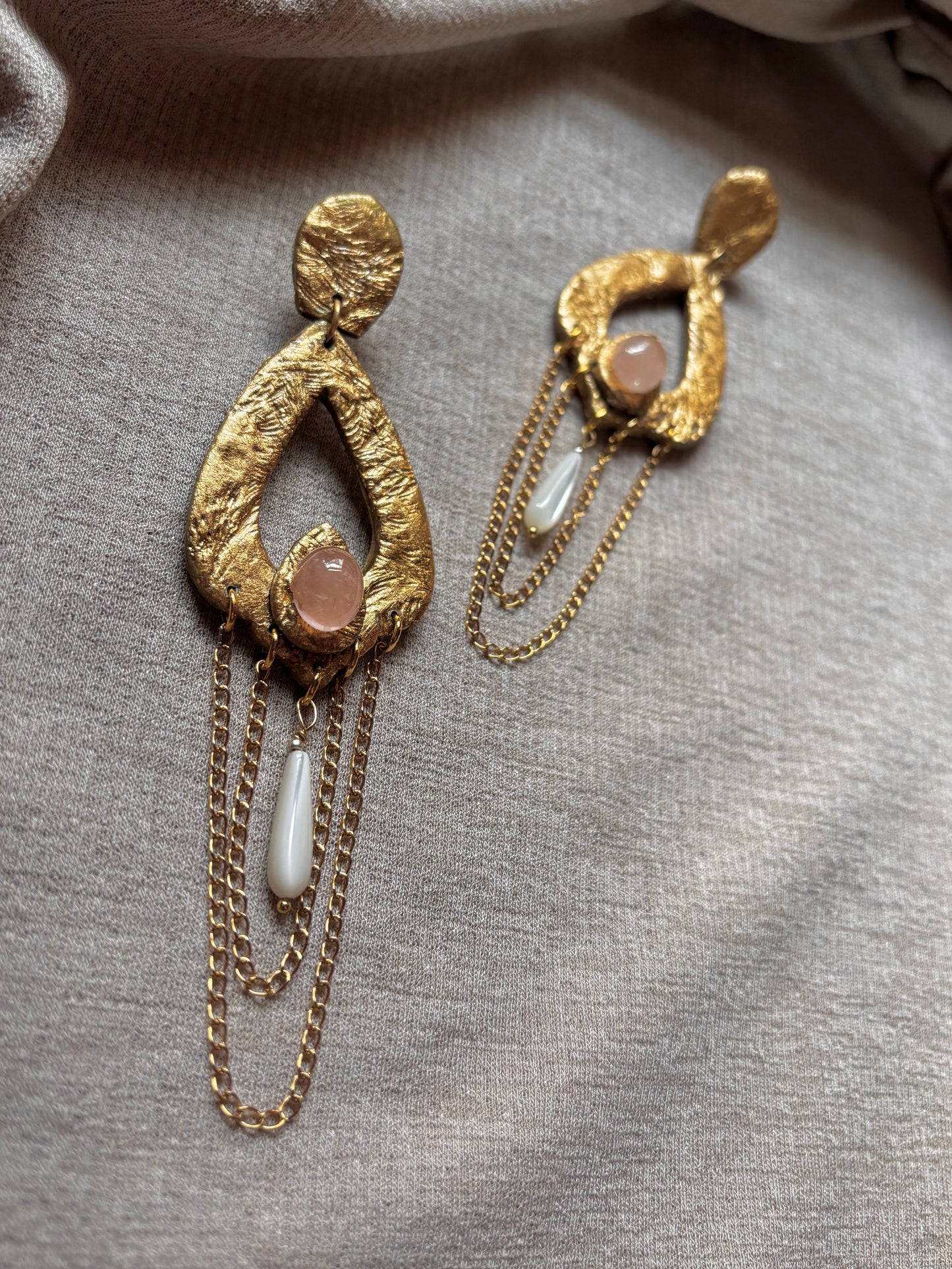 Detail of rose quartz on Caspara Chain Chandelier earrings