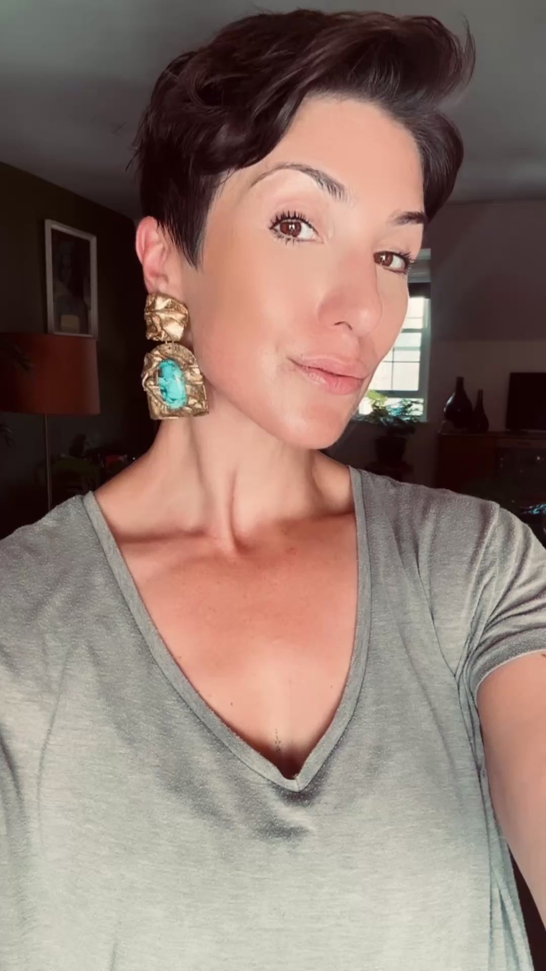 Model wearing Ava & Azar handcrafted arch draped Farideh statement earring sculpted with copper turquoise stones