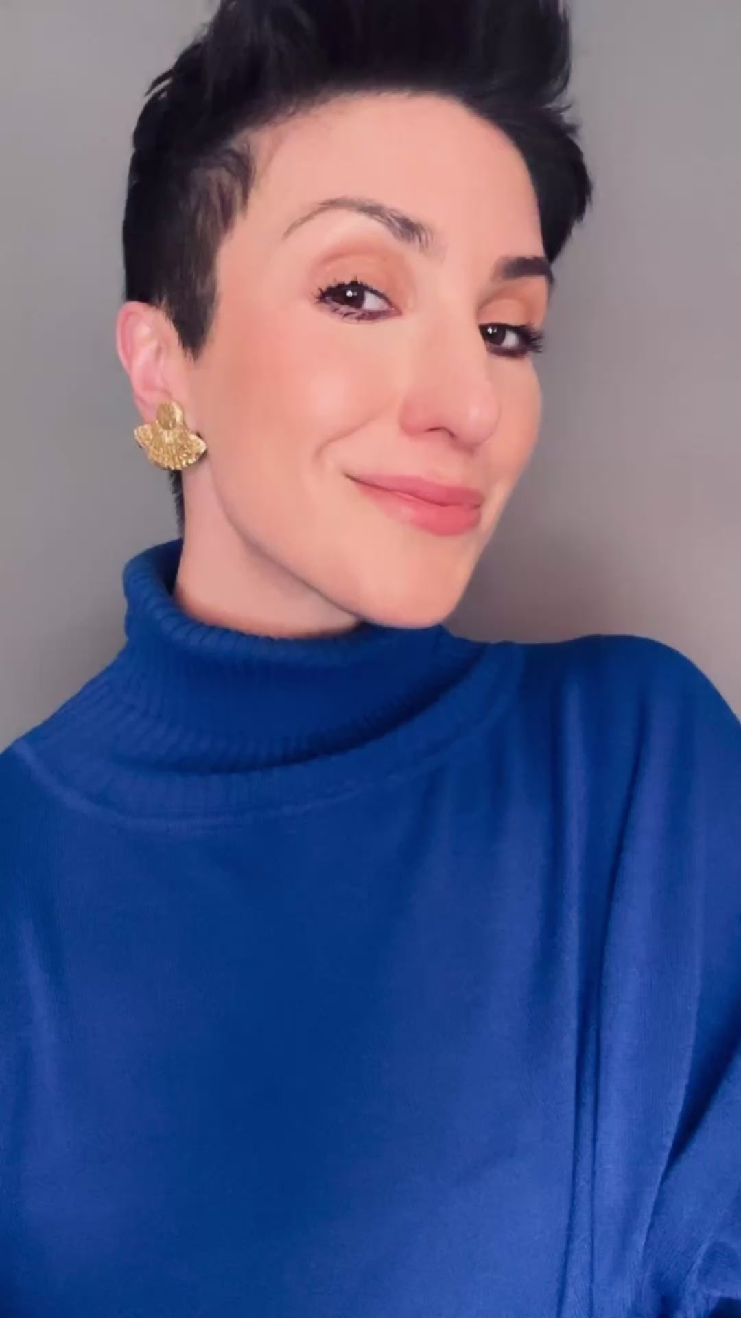 Model wearing Tahmina Ava & Azar handcrafted fan stud gold earrings clip ons non pierced