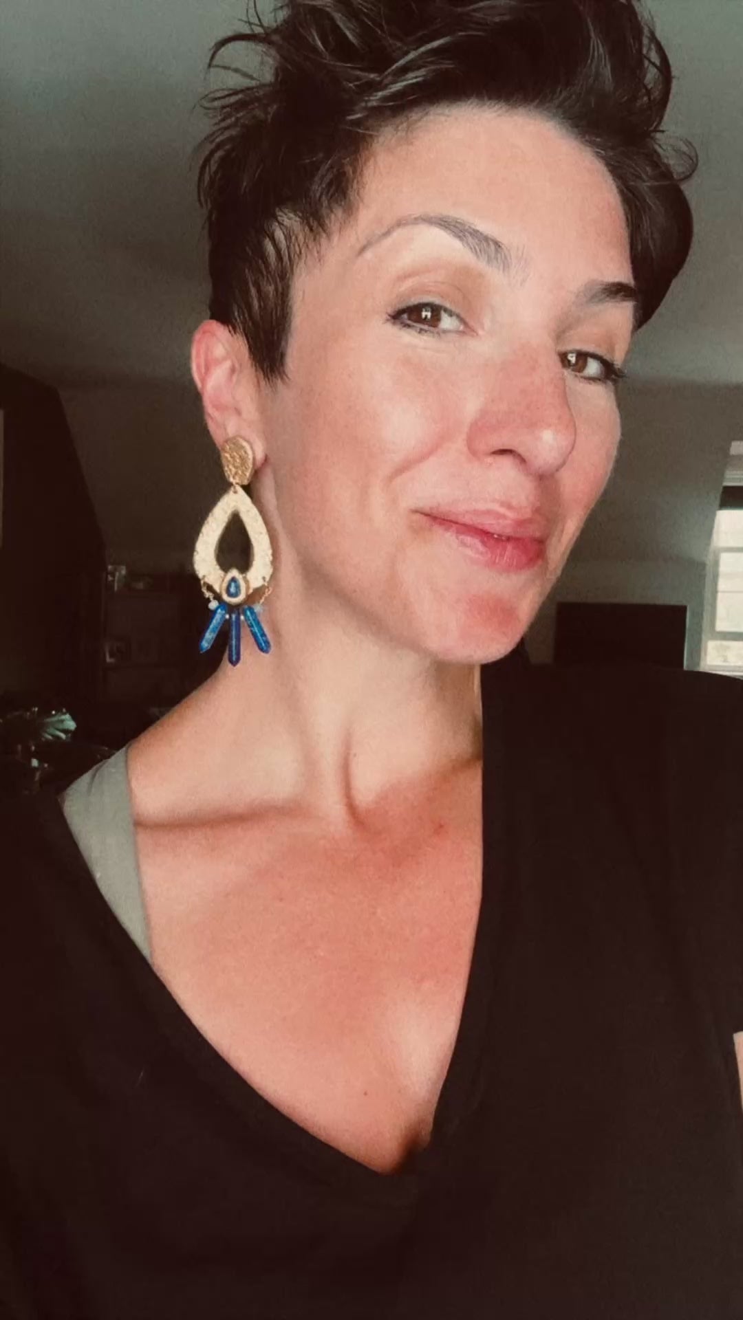 Model wearing Ava & Azar handcrafted gold statement Caspara earrings with lapis lazuli chandelier drop