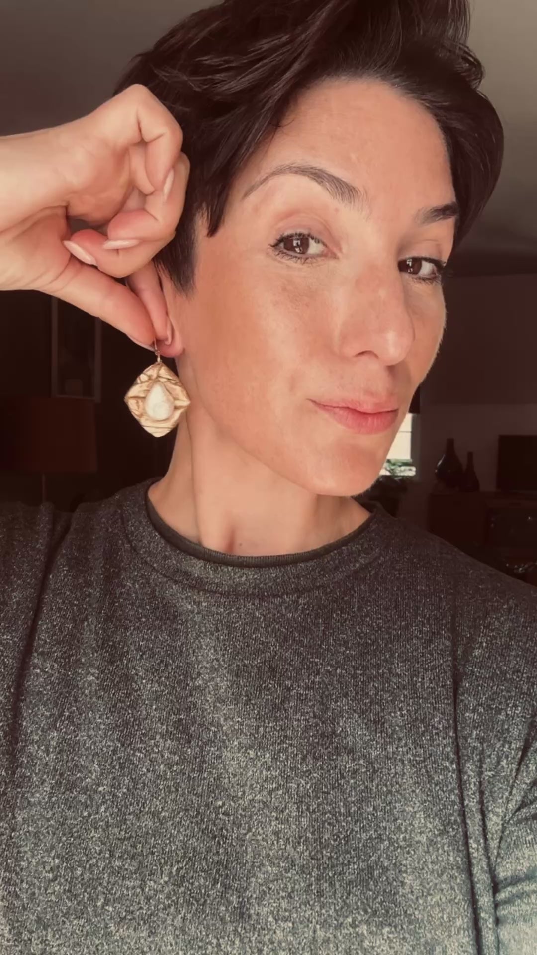 Model wearing Ava & Azar handcrafted gold sculptural earrings with freshwater pearls