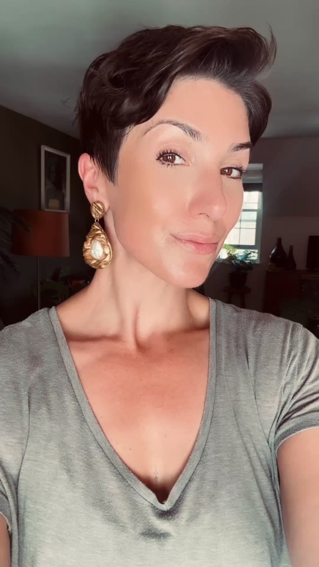 Model wearing Teardrop gold draped sculpted statement earring handcrafted with freshwater pearls