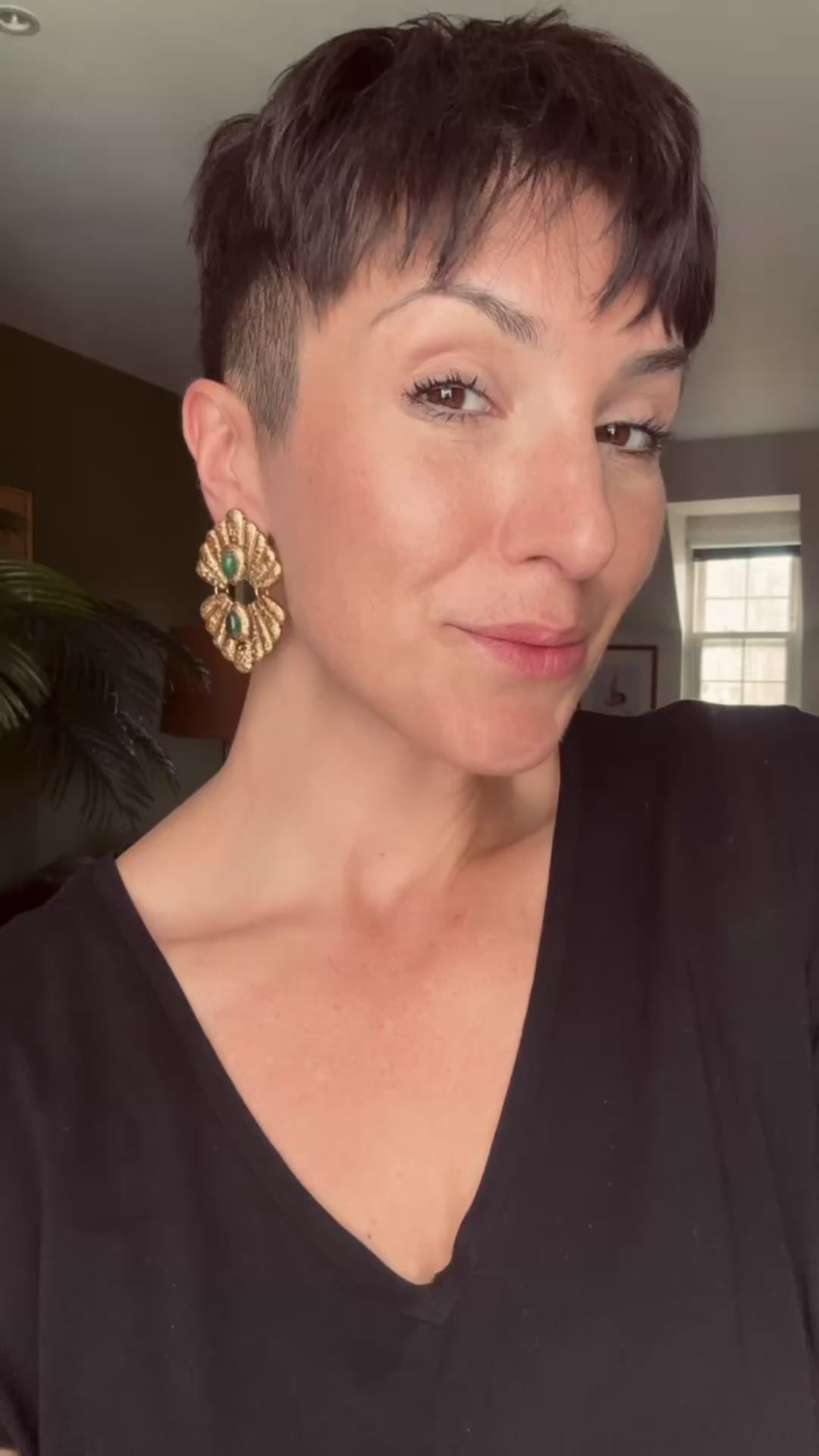 Model wearing the Handcrafted Ava & Azar statement earring called the Caspara, with green Aventurine 