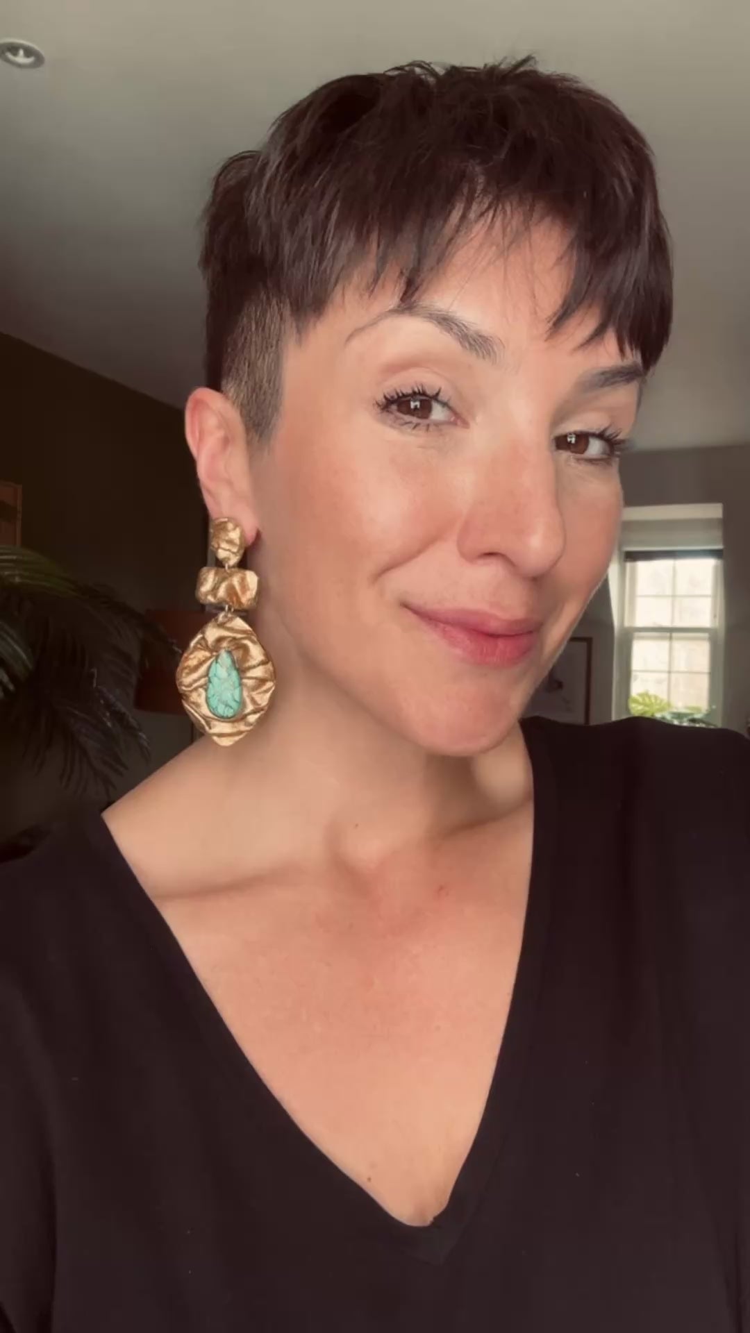 Model wearing Ava & Azar Shahbanu handcrafted statement earrings with copper turquoise stones