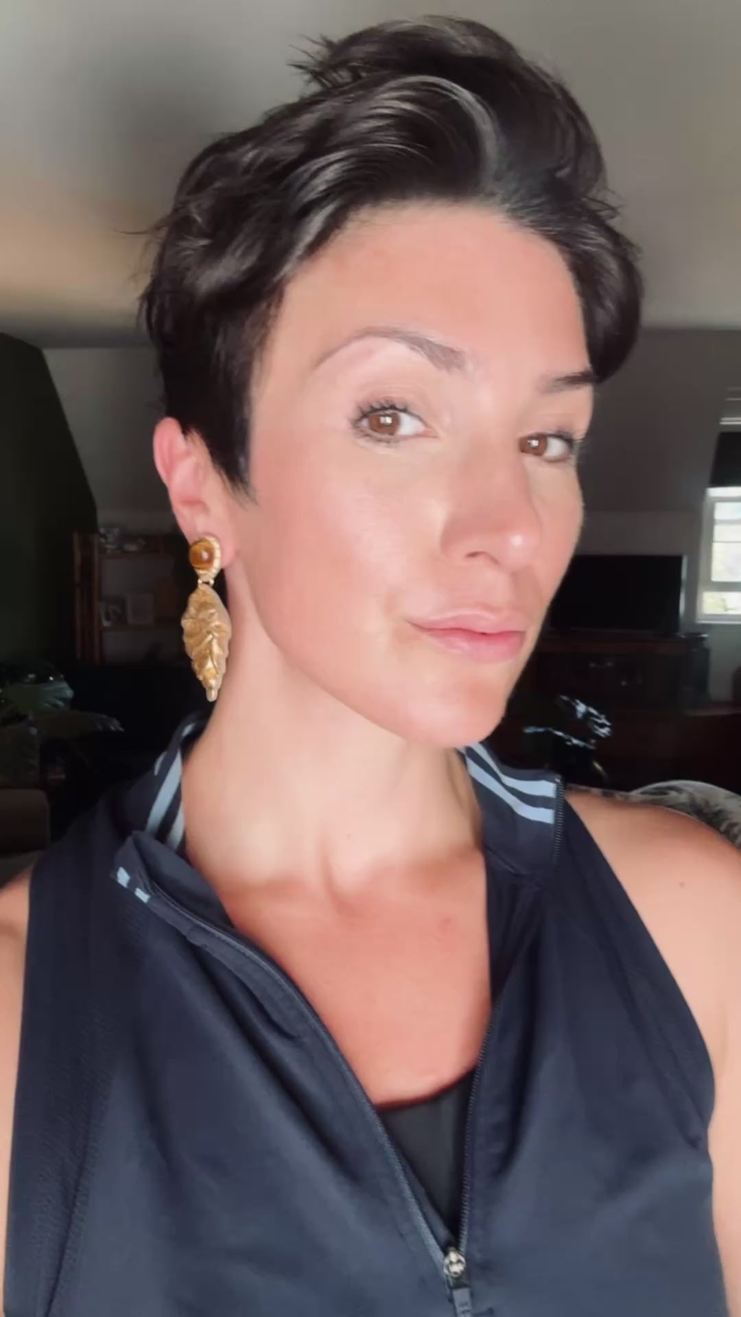 Model wearing Ava & Azar handcrafted Fariba gold earrings with tigers eye