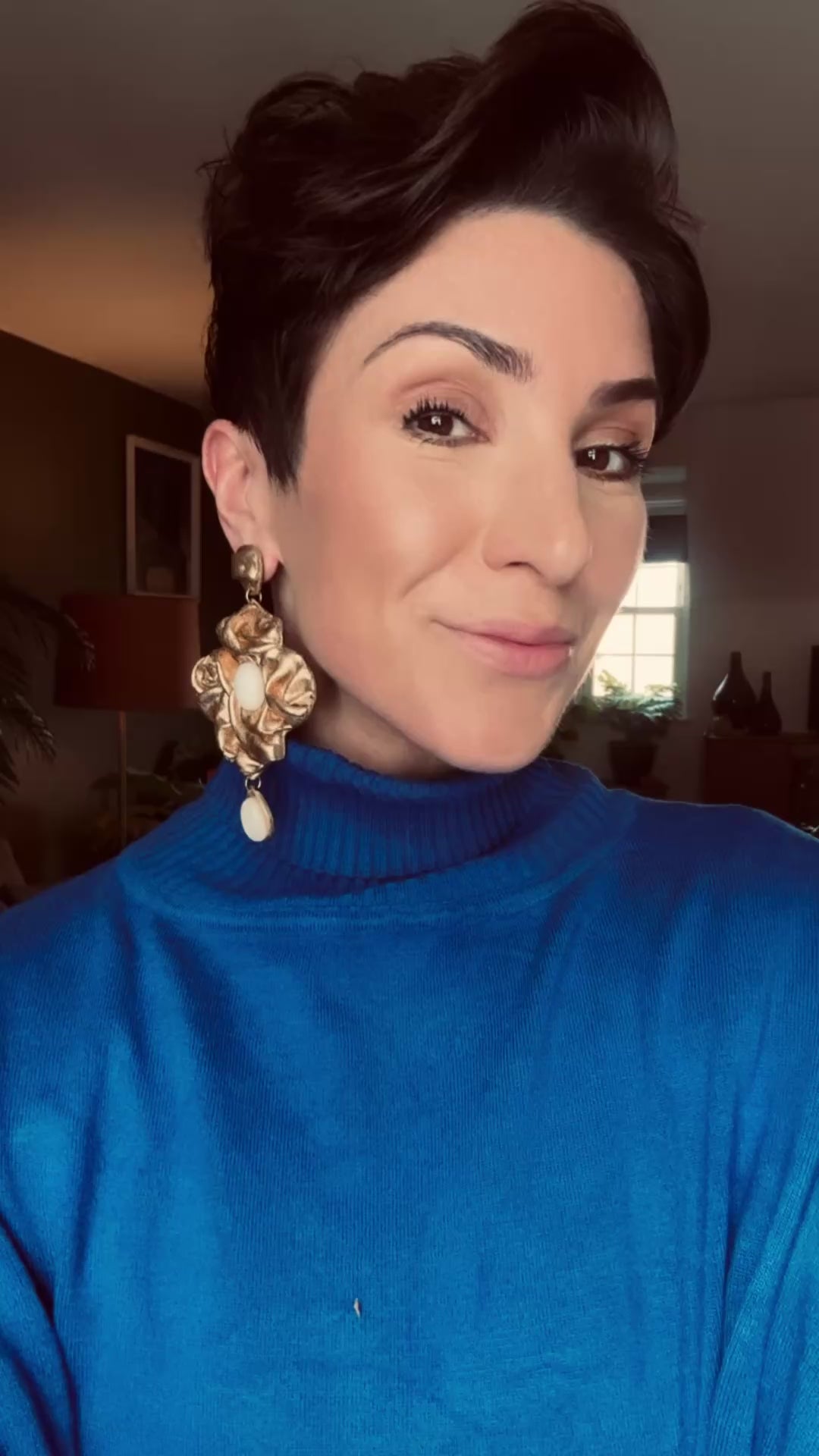 Model wearing Nidara antique gold chandelier earrings